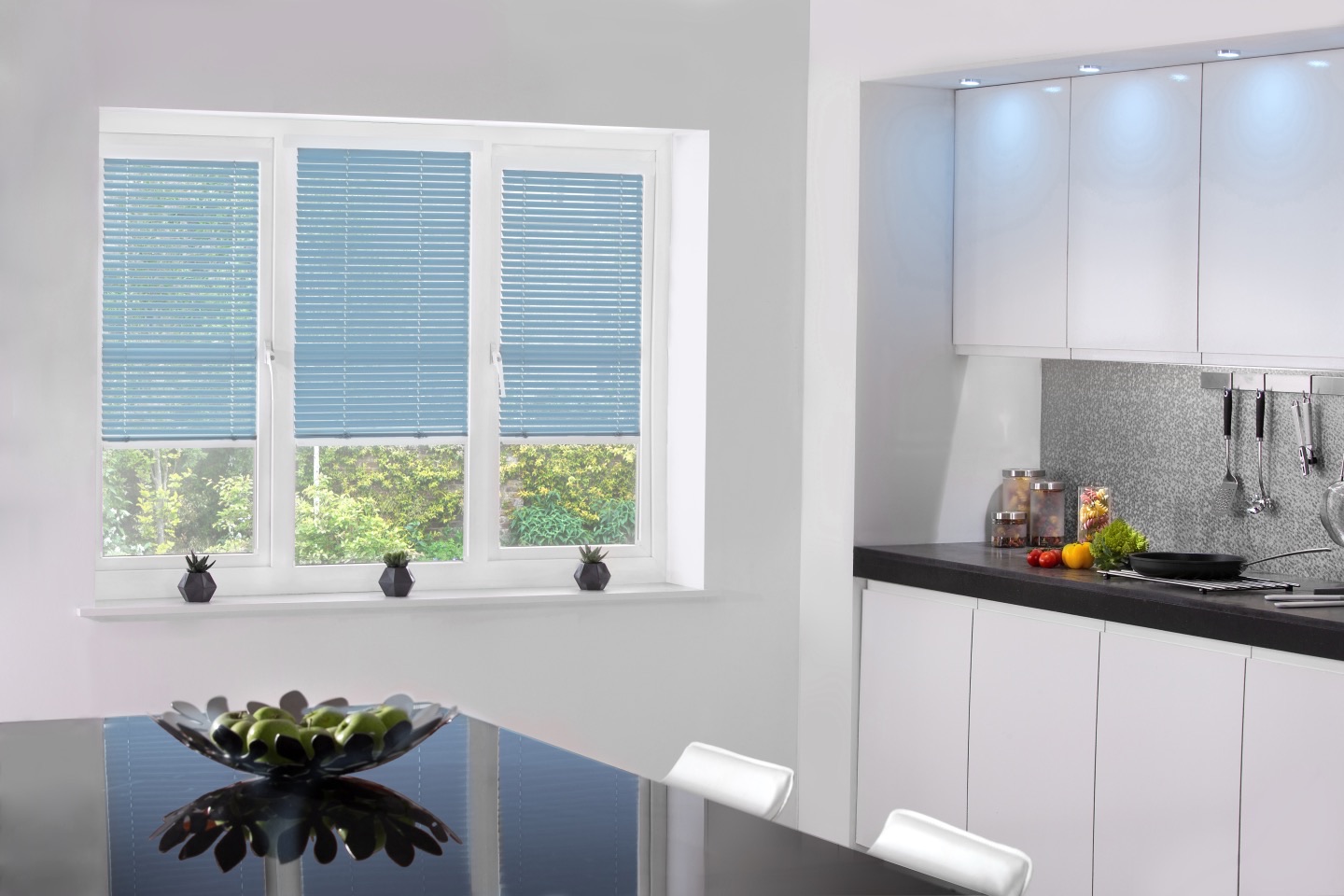 Blue metal Venetian blinds in a contemporary kitchen