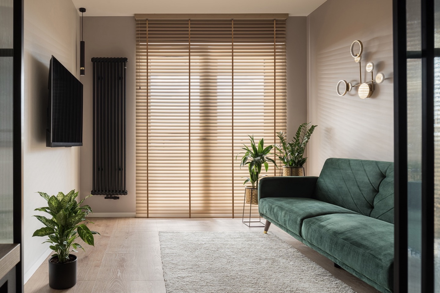 Natural wood Venetian blinds across patio doors in a living room